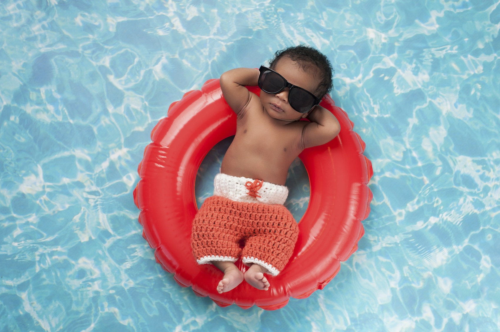 Newborn Baby Boy Floating on a Swim Ring