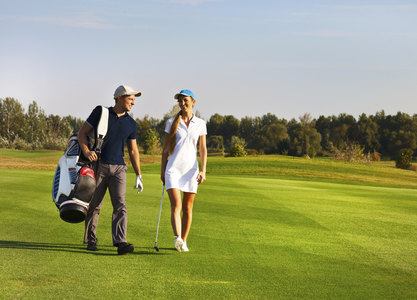 Young sportive couple playing golf