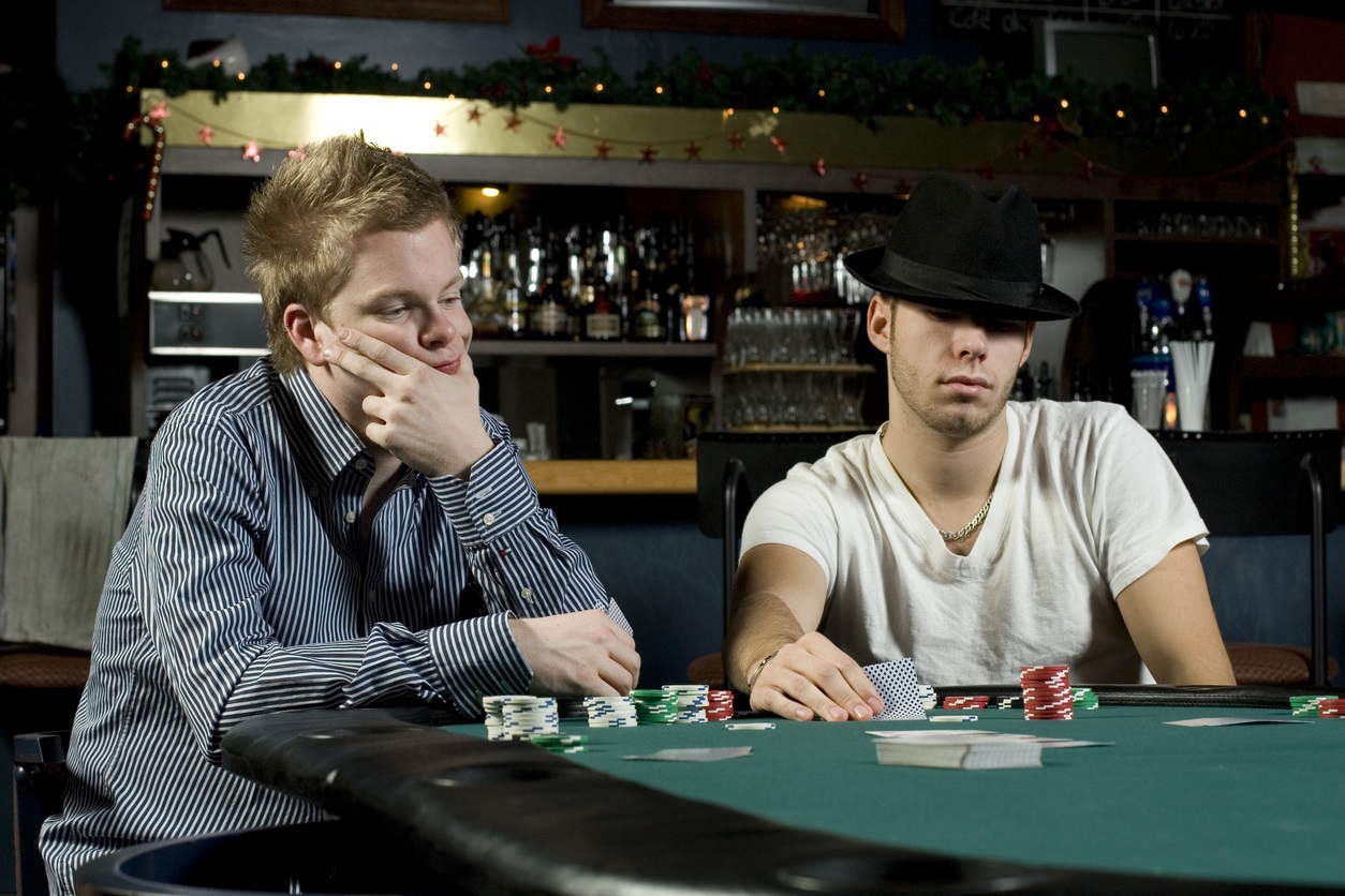 Two card players with poker faces